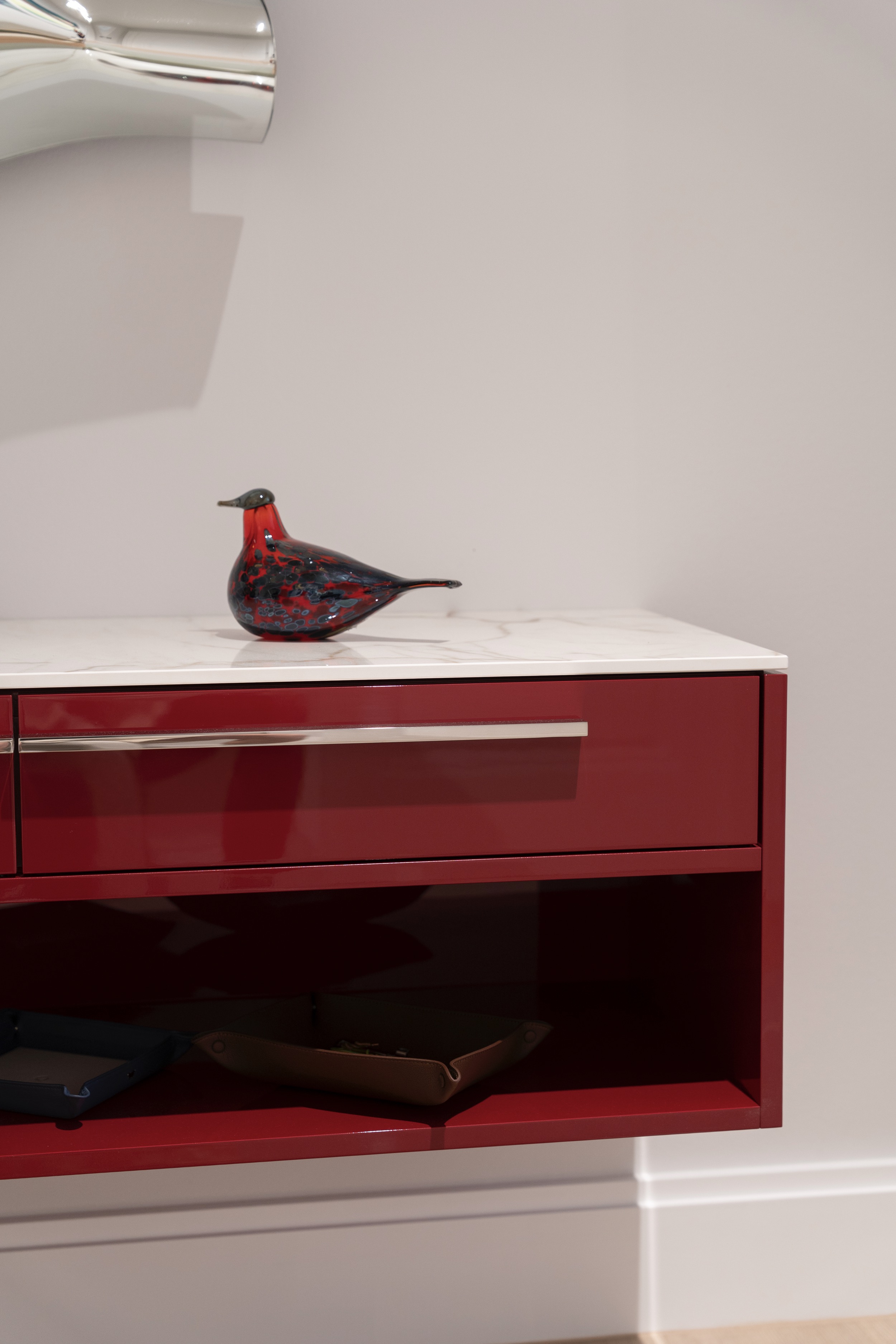 camt-projekt-sideboard-bordeauxrot-hochglanz-nahaufnahme-weisser-marmorauflage-rotes-glasvogel-offenes-fach